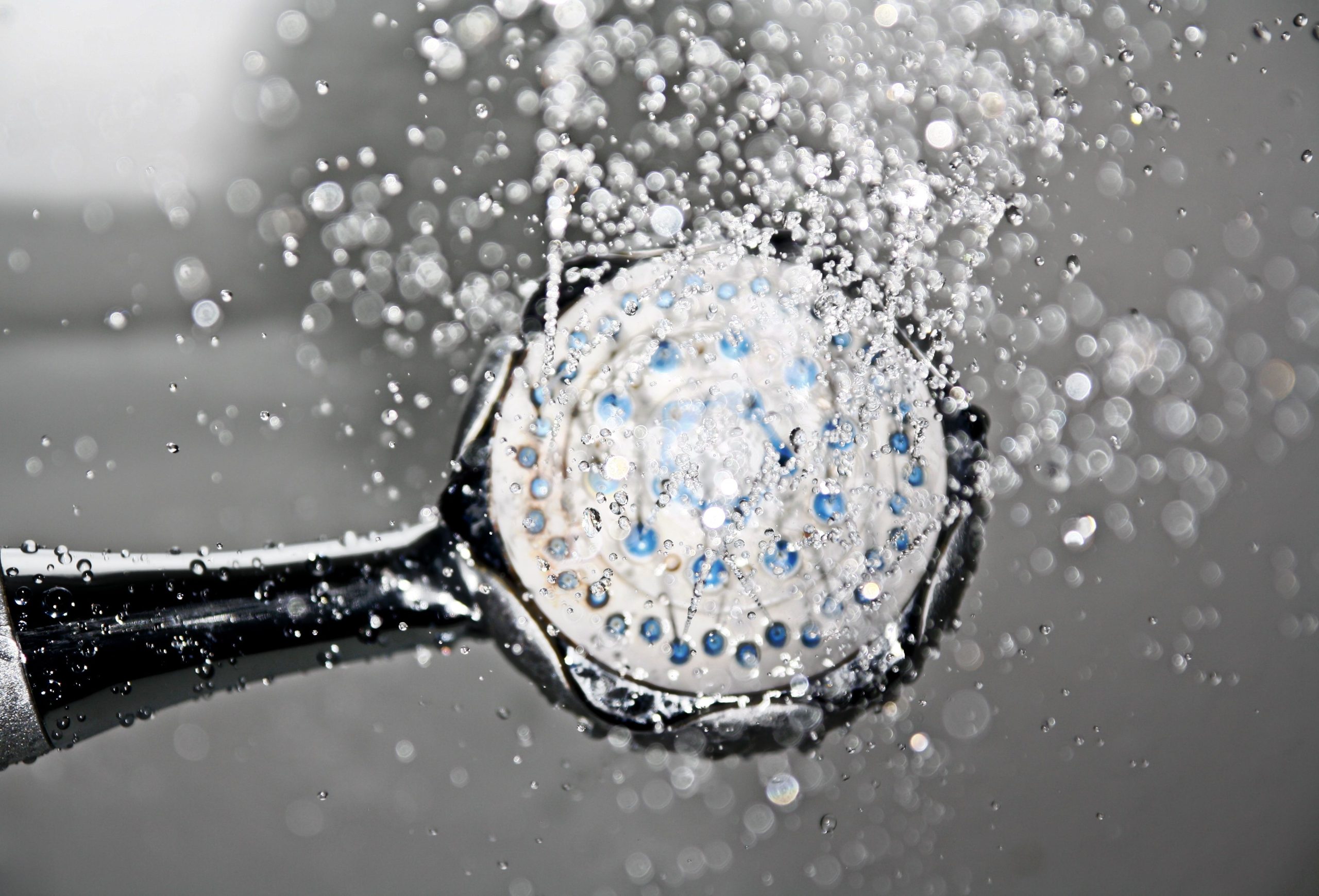 Close-up of a shower head releasing water droplets